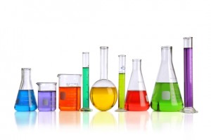 Laboratory glassware with liquids of different colorswith reflections on table